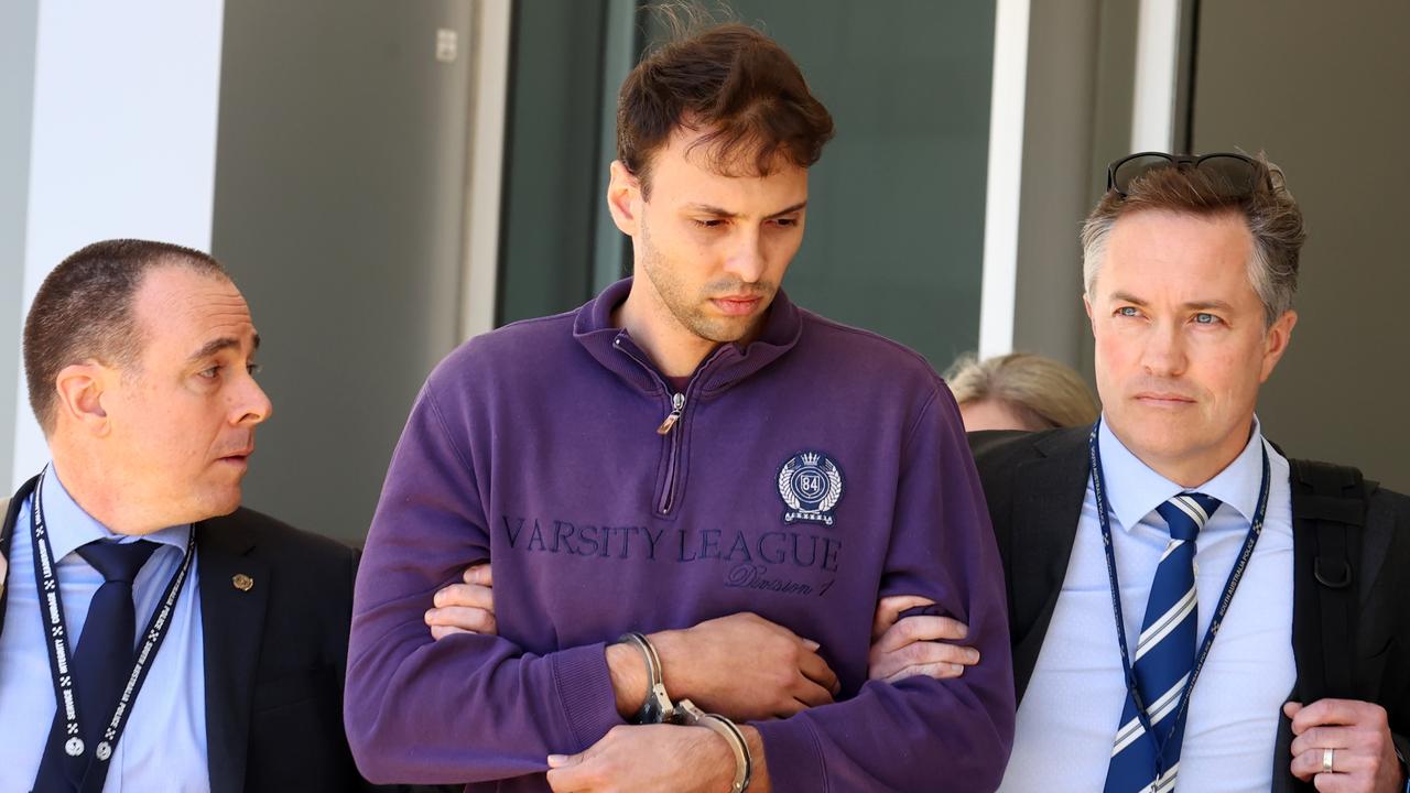 Accused attempted murderer Zacharia Josef Bruckner arrives at Adelaide Airport with police his extradition from Queensland. Picture: NewsWire / Kelly Barnes