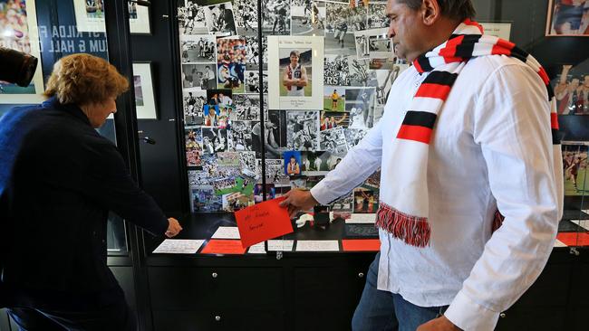 Nicky Winmar pays his respects for ‘Spud’ at the makeshift shrine at St Kilda Football Club. Picture: Mark Stewart