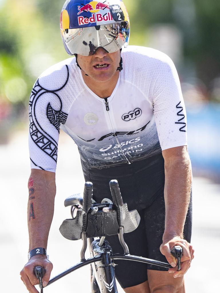 Cairns Iron Man - Braden Currie de-bikes in second place at the endo f the bike leg. Picture: Brian Cassey