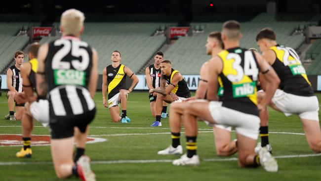 Richmond and Collingwood players take a knee before the opening bounce at the MCG to support the Black Lives Matter movement. Picture: Getty Images