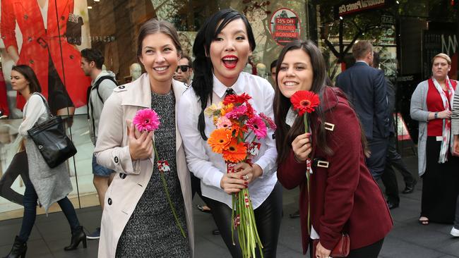 Paying forward ... Singer Dami Im gives out flowers in Pitt Street Mall as random acts of kindness ahead of Smile single release. Picture: Richard Dobson