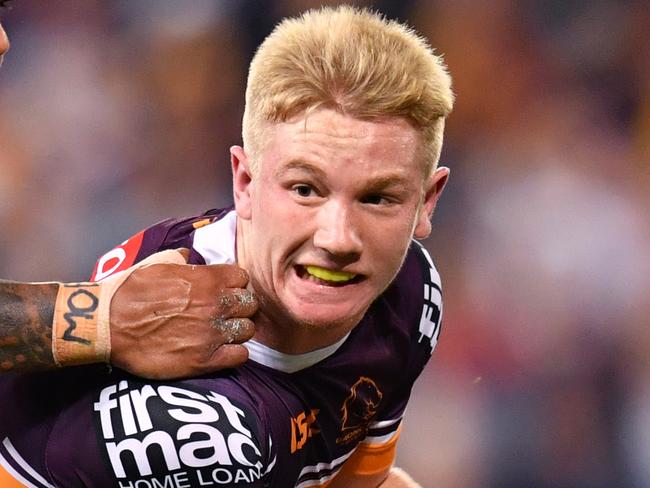 Tom Dearden (right) of the Broncos is tackled by Latrell Mitchell (left) of the Roosters during the Round 10 NRL match between the Brisbane Broncos and the Sydney Roosters at Suncorp Stadium in Brisbane, Friday, May 17, 2019. (AAP Image/Darren England) NO ARCHIVING, EDITORIAL USE ONLY