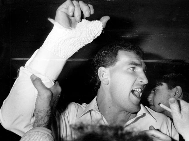 Millane celebrates the 1990 Grand Final win, which he played with a broken thumb.