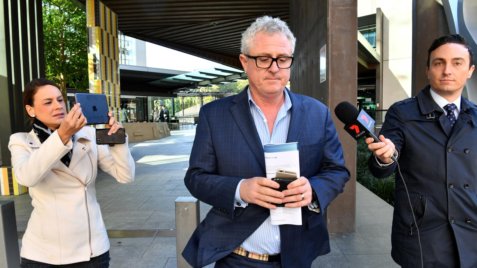 Former property developer Craig Gore leaves the Magistrates Court in Brisbane, Friday, July 21, 2017. The former property developer is expected to apply for legal aid to fight allegations he defrauded superannuation companies of almost $800,000. (AAP Image/Darren England) NO ARCHIVING