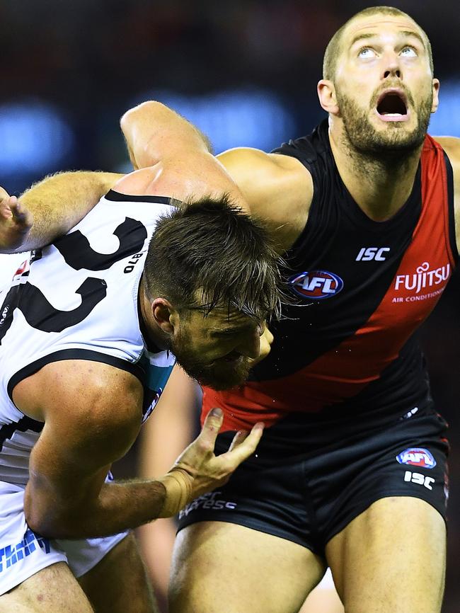 Charlie Dixon is worked out of the ruck contest by Tom Bellchambers on Sunday. Picture: Mark Brake/Getty Images