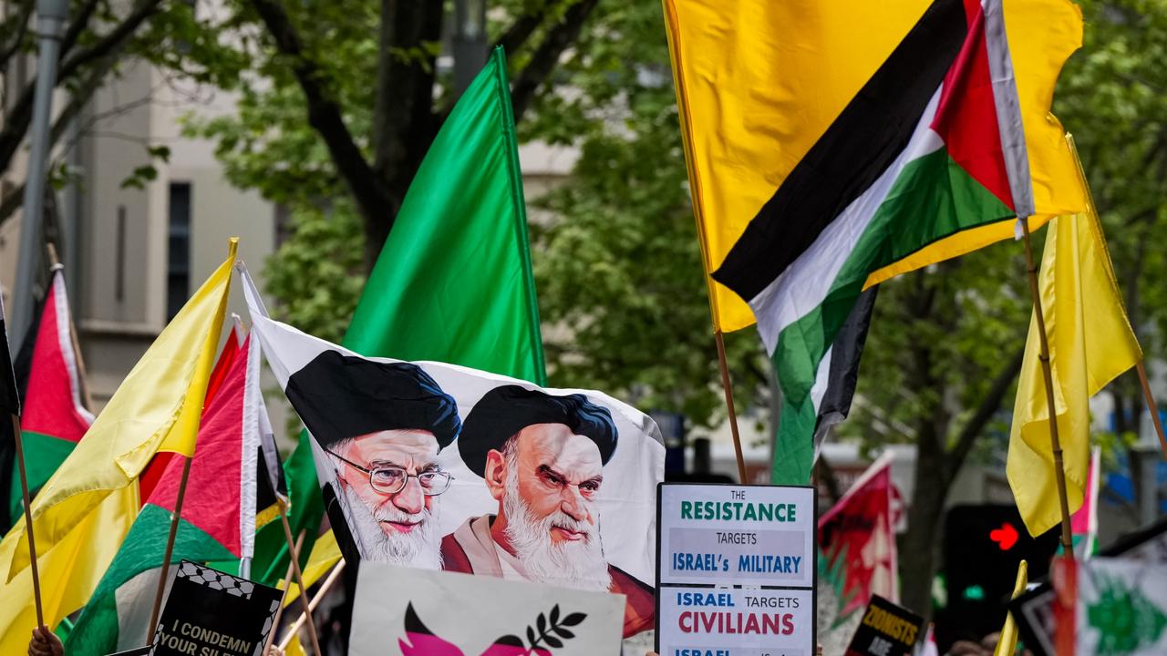 A flag bearing the face of Iran's Supreme Leader, Ayatollah Ali Khamenei is waved on October 06 in Sydney. Picture: Asanka Ratnayake/Getty Images