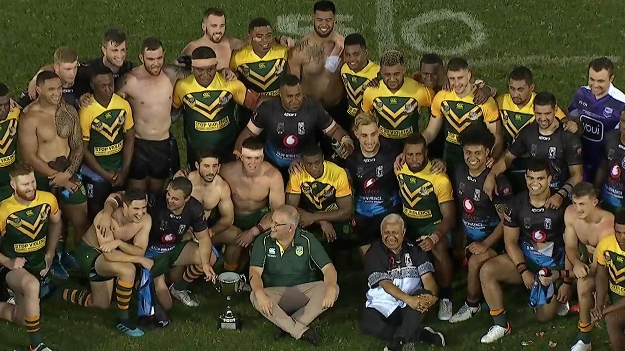 Australia celebrate their 52-10 win with Fiji players and the Prime Minister's of both countries.