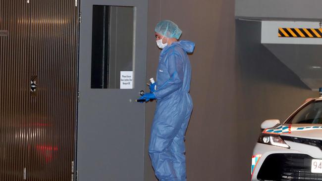 A forensic investigator at the Newport Apartments in Hamilton after a body was discovered. Picture: David Clark