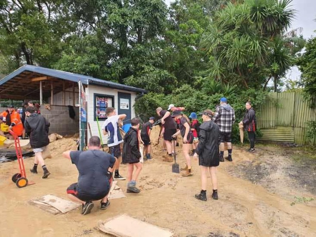 Members of the Central Coast Bombers senior and junior teams have helped Wyong SES bag 50 tonnes of sand bags over the past three days as residents prepare for more localised flooding. Picture: Wyong SES