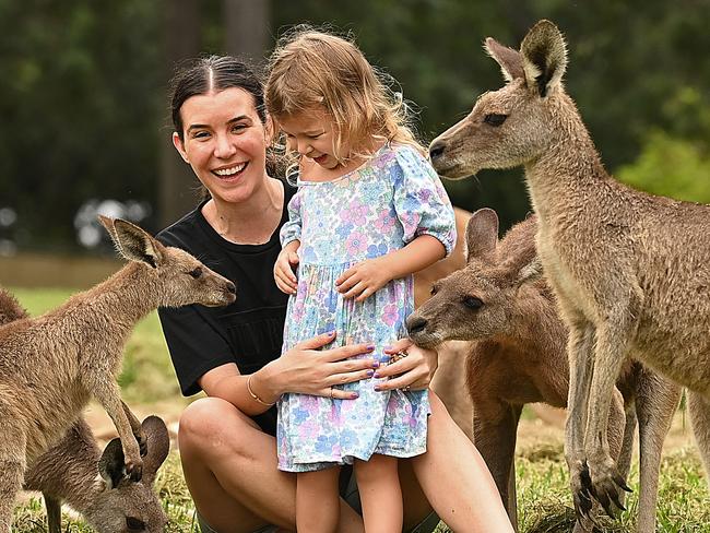 26/01/2022 : Former English citizens,  Victoria de Jonge with Matilda, 2,  now both naturalised Australians, share a gentle and quintessential Aussie moment among the kangaroos at Lone Pine Koala Sanctuary on Australia Day, in Fig Tree Pocket, Brisbane. The family returned to Australia from London at the height of covid in 2020 for a better life, with Victoria crying with joy when they landed. Lyndon Mechielsen/The Australian