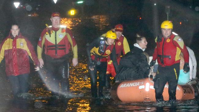 Residents being evacuated by Surf Rescue from their home in Mactier St, Narrabeen, near Narrabeen lagoon, due to flooding in February, 2020. Picture by Damian Shaw