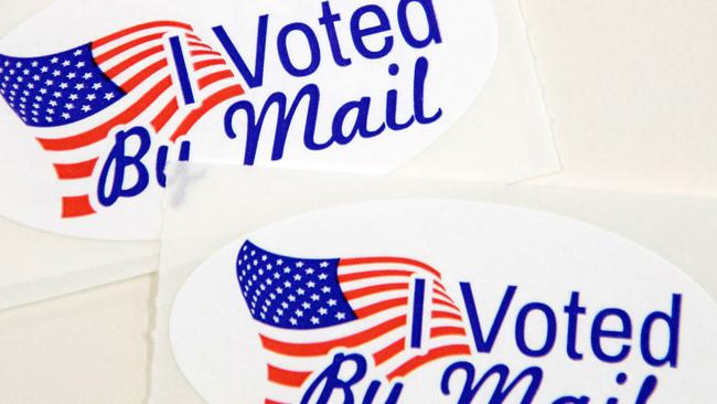 Stickers reading "I Voted By Mail" are placed into envelopes by absentee ballot election workers at the Mecklenburg County Board of Elections office in Charlotte, North Carolina. Picture: AFP.