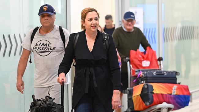 Queensland Premier Annastacia Palaszczuk, with partner Dr Reza Adib, arrives at Brisbane International Airport on Sunday night after her overseasl holiday, to face leadership unrest as she returns to work on Monday. Picture: Lyndon Mechielsen