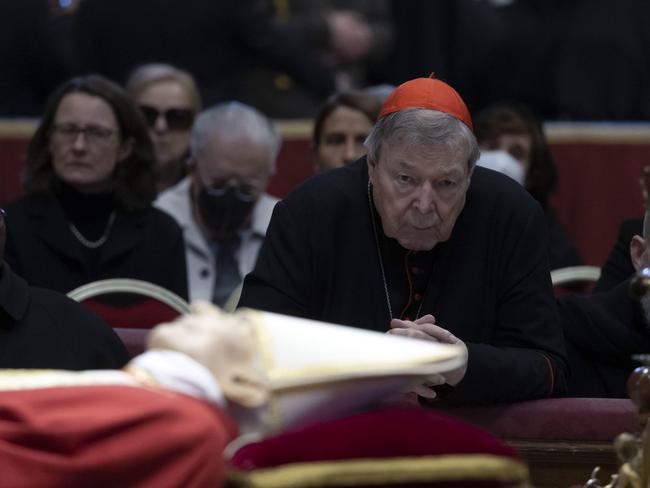 Last picture: Cardinal Pell prays near the body of the late Pope Emeritus Benedict XVI on January 3. Picture: EPA/Massimo Percossi