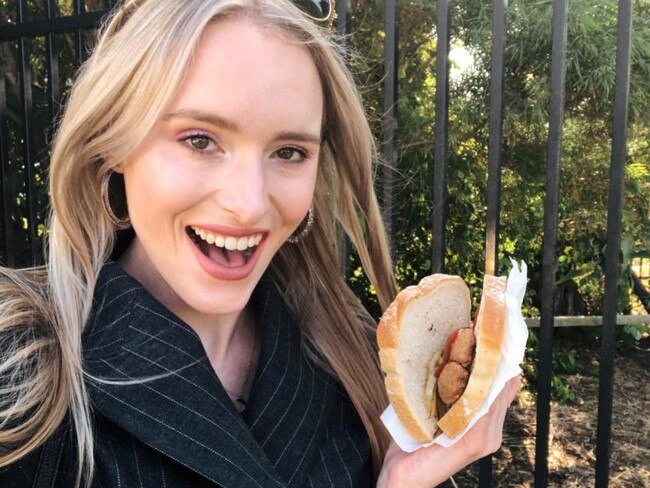 Eliza Barr trying a sausage in Cronulla.