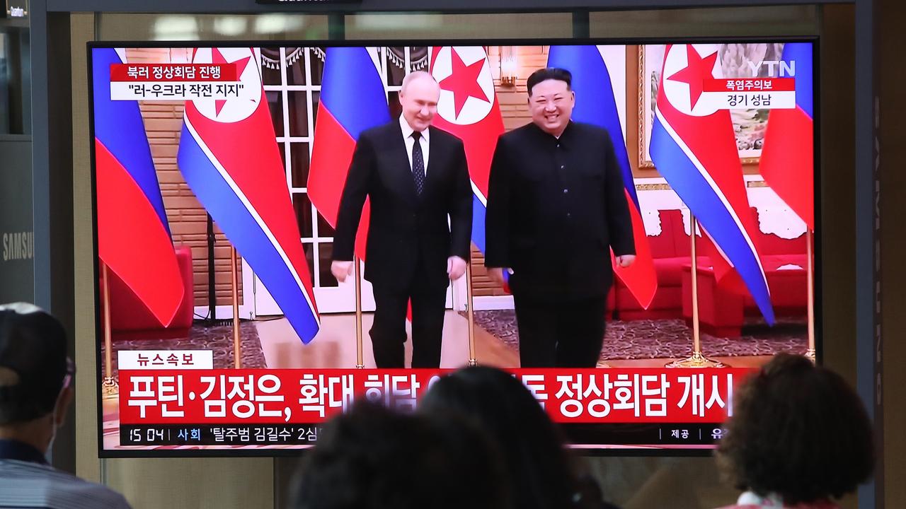 People watch a television broadcast reporting a meeting between North Korean leader Kim Jong-un and Russian President Vladimir Putin at the Seoul railway station on June 19, 2024. (Photo by Chung Sung-Jun/Getty Images)