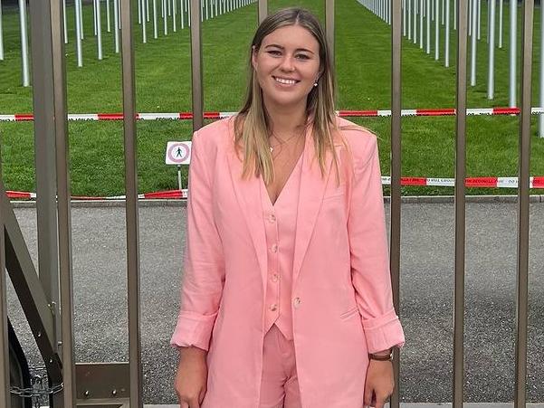 Brittany Higgins poses for pictures outside the UN building in Geneva.