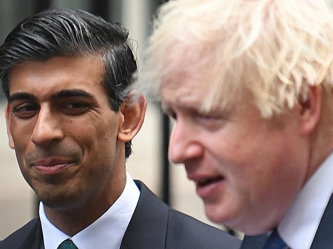 (FILES) In this file photo taken on December 01, 2021 Britain's Prime Minister Boris Johnson (R) stands with Britain's Chancellor of the Exchequer Rishi Sunak during a meeting with Small Business Saturday entrepreneurs in Downing Street in central London. - UK Prime Minister Boris Johnson and finance minister Rishi Sunak will face fines for breaching Covid-19 lockdown laws stemming from the "partygate" scandal, a Downing Street spokeswoman said on April 12, 2022. "The Prime Minister and Chancellor of the Exchequer have today received notification that the Metropolitan police intend to issue them with fixed penalty notices," she said. (Photo by Daniel LEAL / AFP)