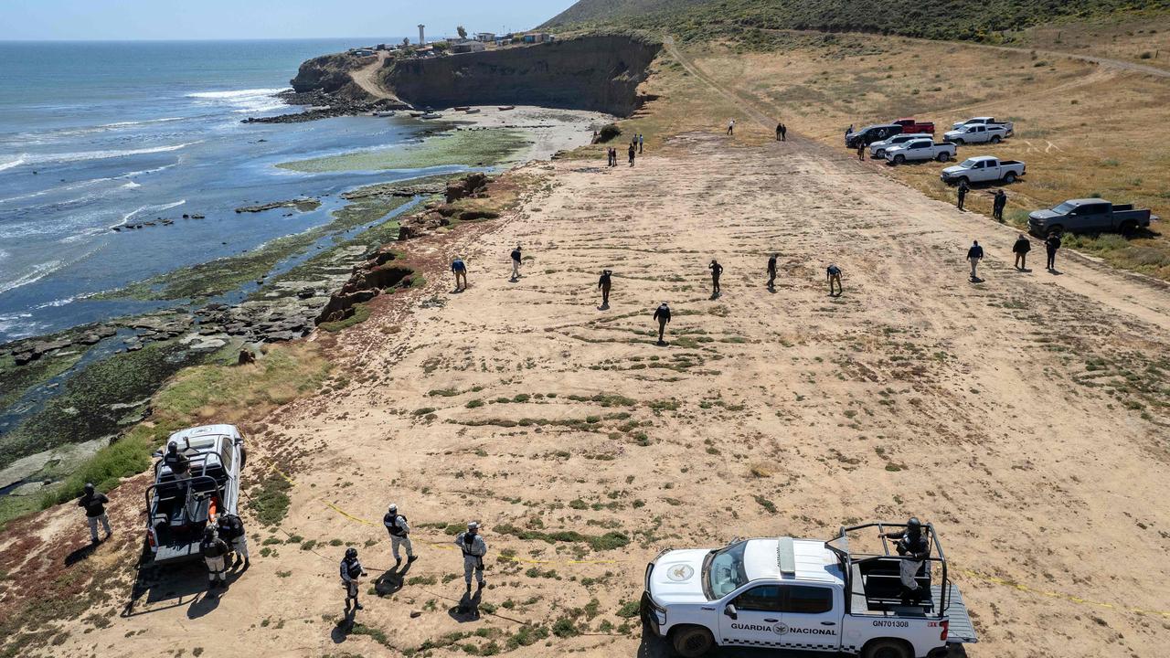 State prosecutors running a search at the site where three surfers were camping before disappearing. Picture: Guillermo Arias / AFP