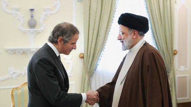 Iran's President Ebrahim Raisi (R) welcoming International Atomic Energy Agency (IAEA) chief Rafael Grossi ahead of their meeting in Tehran.