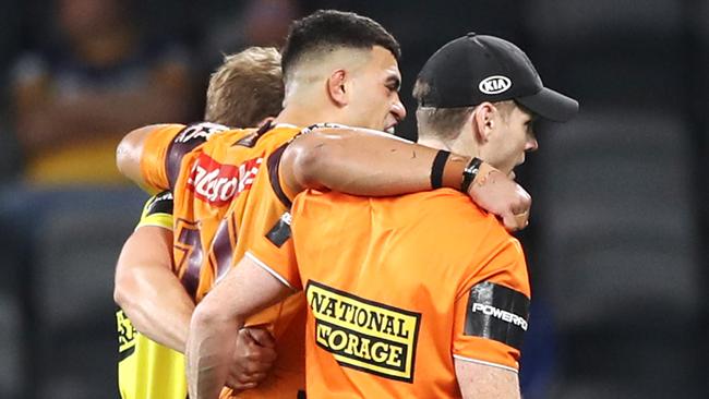 David Fifita of the Broncos is assisted from the field after injuring his ankle. Picture: Mark Kolbe/Getty Images.