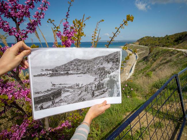 During a battlefield tour of Anzac Cove, an ADF Contingent member holds up a photo of the  landing site during the Gallipoli Campaign in 1915. 