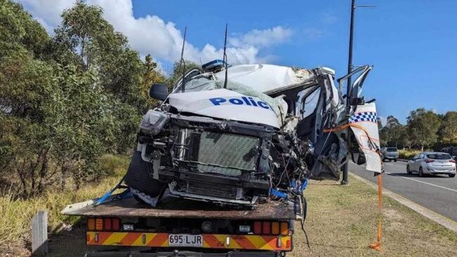 A police car is removed from the scene of the crash at Anzac Ave at Mango Hill.