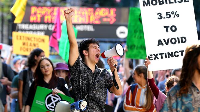 Protesters including Connor Brooks (centre) in the Brisbane CBD marching down George Street to parliament, Tuesday August 6. Picture: AAP/David Clark