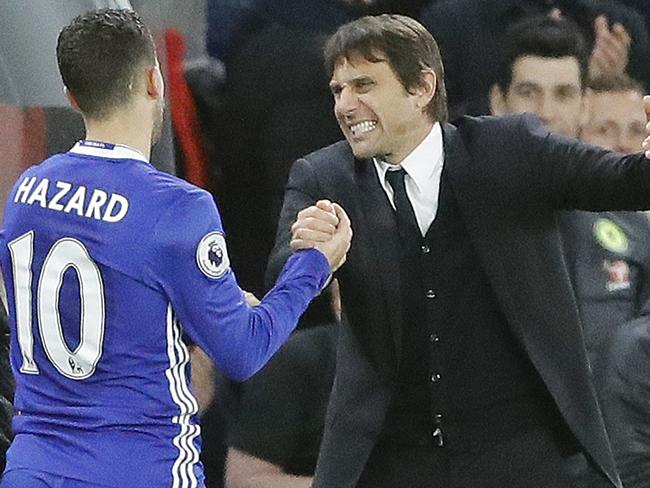 Chelsea's Eden Hazard, left, and Chelsea's team manager Antonio Conte celebrate after winning the English Premier League soccer match between Chelsea and Bournemouth at Stamford Bridge stadium in London, Monday, Dec. 26, 2016.(AP Photo/Frank Augstein)