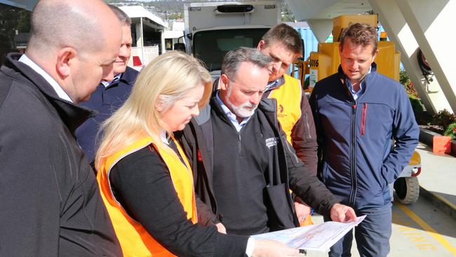 David O’Byrne, centre, shows his party’s 10-year transport vision to members of the civil construction industry at Wrest Point.