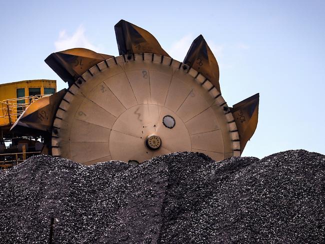 An excavator on a pile of coal at the Port of Newcastle. Photographer: David Gray/Bloomberg