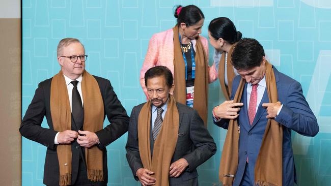 Canada's Prime Minster Justin Trudeau, right, Prime Minister Anthony Albanese, left, and Sultan of Brunei Haji Hassanal Bolkiah, centre, participate in a family photo during the APEC summit in Lima, Peru.