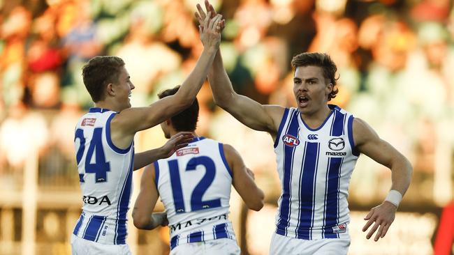 LAUNCESTON, AUSTRALIA - MAY 15: Cameron Zurhaar of the Kangaroos celebrates a goal with Tom Powell during the 2021 AFL Round 09 match between the Hawthorn Hawks and the North Melbourne Kangaroos at UTAS Stadium on May 15, 2021 in Launceston, Australia. (Photo by Dylan Burns/AFL Photos via Getty Images)