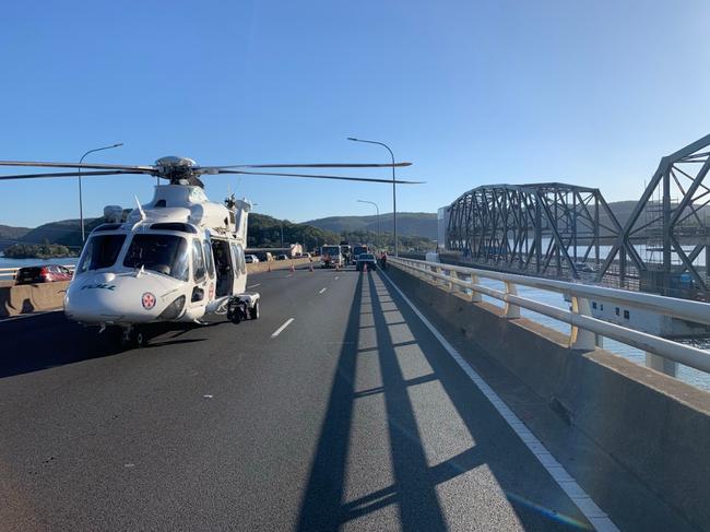A Toll rescue helicopter landed at the scene to assist transporting the injured driver. Picture: Live Traffic NSW
