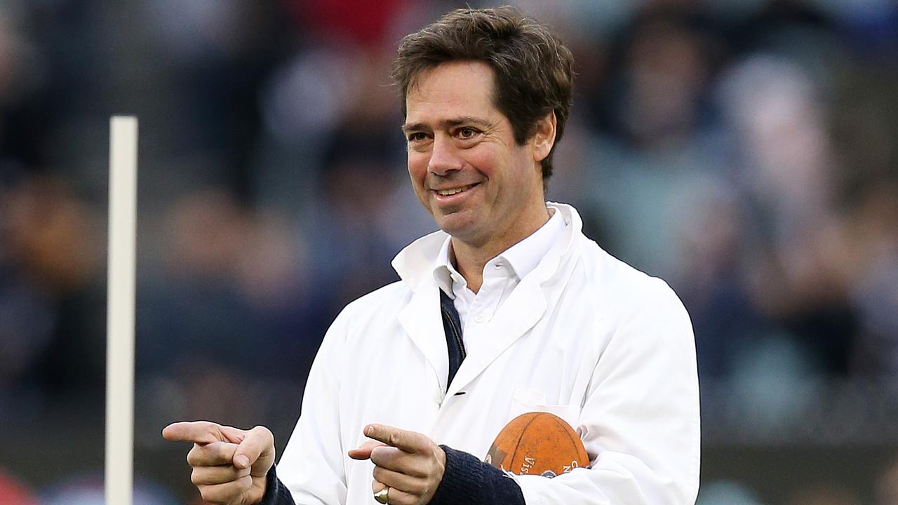 AFL CEO Gillon McLachlan acts as the goal umpire for a halftime Auskick game in 2018. Photo: Michael Klein