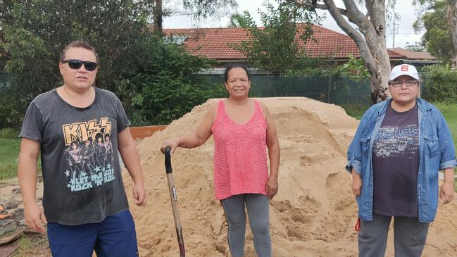 (L - R) Carlos Silva, Miriam Silva and Xiomara Cisneros at the Fairfield SES headquarters, collecting sand to protect their home. Picture: Paul Brescia