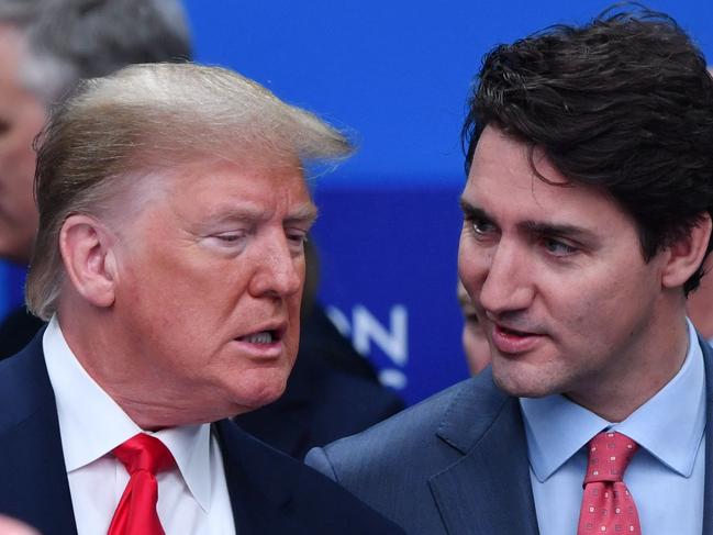 (FILES) US President Donald Trump (L) talks with Canada's Prime Minister Justin Trudeau during the plenary session of the NATO summit at the Grove hotel in Watford, northeast of London, on December 4, 2019. (Photo by Nicholas Kamm / AFP)