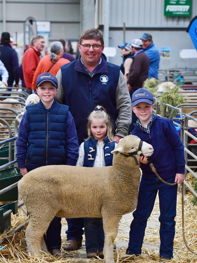 James Frost from Hillden Poll Dorsets with his kids Alice, 11, Edie, 5, and Harry, 9, and a three-month-old lamb. Picture: Zoe Phillips