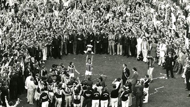 Port Adelaide’s Russell Ebert holds the 1977 premiership cup aloft at AAMI Stadium after a 12-year drought for Port Adelaide.