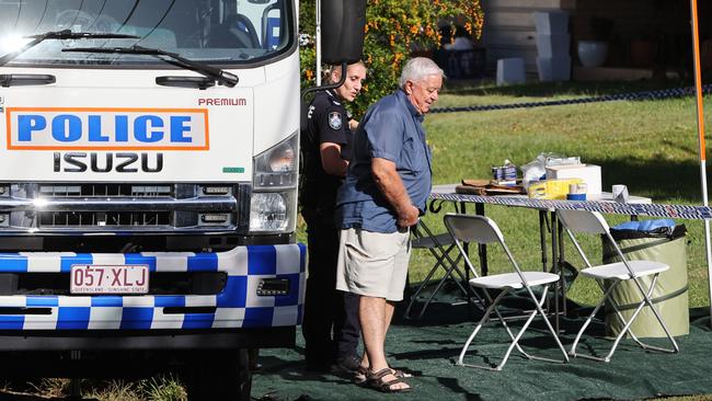 A man speaks with police outside the Molendinar home. Picture: NIGEL HALLETT