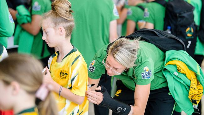 Matilda's soccer player Alanna Kennedy signing a fan's shirt.