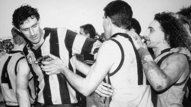 Michael Tuck, Darren Jarman and John Platten at the end of the 1991 qualifying final. Photo: Norm Bailey/Newscorp