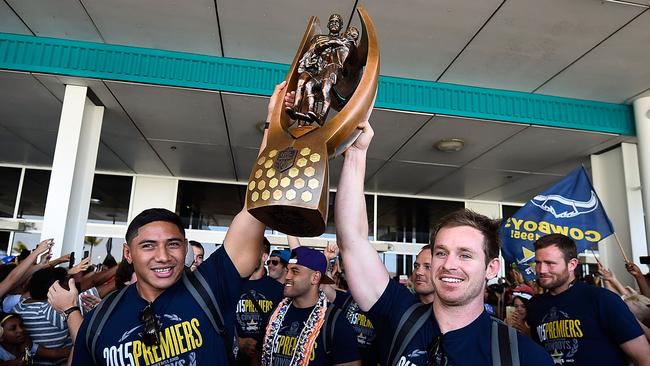 TOWNSVILLE, AUSTRALIA - OCTOBER 05: Jason Taumalolo and Michael Morgan of the Cowboys hold the NRL trophy aloft after arriving back at the Townsville airport before heading out to the North Queensland Cowboys NRL Grand Final fan day at 1300 Smiles Stadium on October 5, 2015.