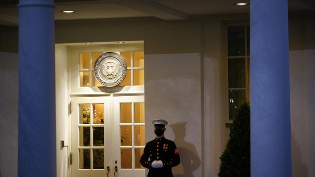 A US Marine stands guard outside the West Wing at dusk on Donald Trump's final full day in office. Picture: AFP