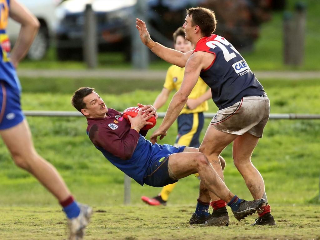 Northern: Banyule’s Nick Biscontin takes a strong mark against Jai Norman of Diamond Creek. Picture: Stuart Milligan