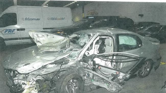 The mangled wreck of the Saab driven by Mathew Dyer that killed his front seat passenger and friend Nicole Woollard.