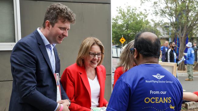 Jacinta Allan and Labor candidate John Lister greet a voter at a Werribee polling booth on Saturday. Picture: Ian Currie