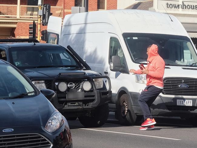 The tradie, driving a black ute, and the shop owner on the street outside McDonald’s where witnesses said there was almost a collision.