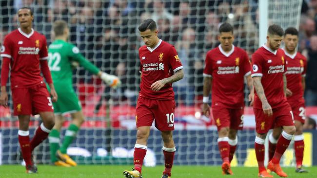 Philippe Coutinho of Liverpool and his Liverpool teammates look dejected.