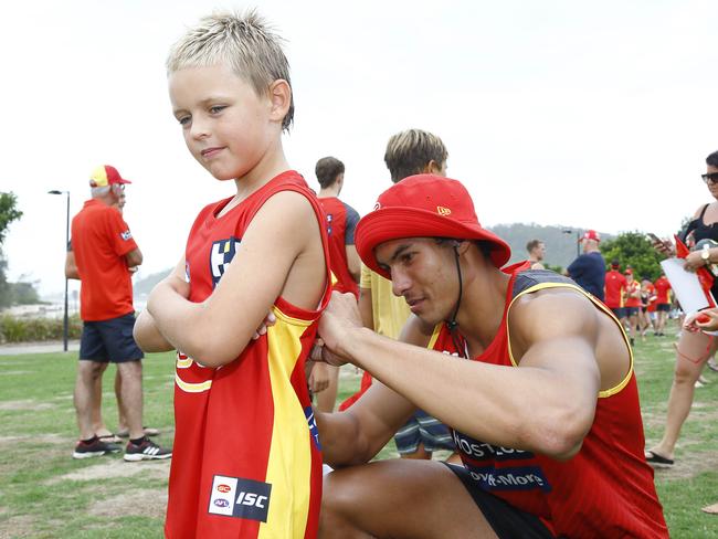 Gold Coast Suns player Patrick Murtagh with a fan at Palm Beach. Picture: Tertius Pickard